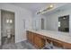 Bathroom vanity with bright lighting, large mirrors, and modern fixtures at 2921 Wickford Nw Dr, Kennesaw, GA 30152