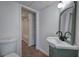 Full bathroom with tiling, ample lighting, and an attractive green vanity with sink at 2921 Wickford Nw Dr, Kennesaw, GA 30152