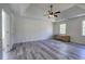 Large primary bedroom with refinished floors, and a tray ceiling with ceiling fan at 2921 Wickford Nw Dr, Kennesaw, GA 30152