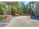 Large driveway leads to a fenced backyard with a basketball hoop and a two-car garage at 2921 Wickford Nw Dr, Kennesaw, GA 30152
