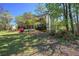 Attractive brick home with mature trees, colorful flower beds, and a sprawling lawn at 2921 Wickford Nw Dr, Kennesaw, GA 30152