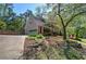 View shows a brick home with an attached garage and a long driveway; basketball hoop in backyard at 2921 Wickford Nw Dr, Kennesaw, GA 30152