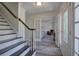 Inviting foyer with staircase, wood flooring, and glass doors leading to the living area at 2921 Wickford Nw Dr, Kennesaw, GA 30152