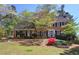Charming two-story brick home with manicured lawn and flowering trees, offering classic curb appeal at 2921 Wickford Nw Dr, Kennesaw, GA 30152