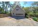 Two-car garage sits at the end of a concrete driveway near a wooden privacy fence at 2921 Wickford Nw Dr, Kennesaw, GA 30152