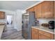 Kitchen showcasing stainless steel refrigerator, sleek counters and light oak cabinets at 2921 Wickford Nw Dr, Kennesaw, GA 30152