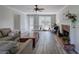 Bright living room with refinished floors, built-in shelves, and a brick fireplace at 2921 Wickford Nw Dr, Kennesaw, GA 30152
