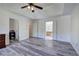 Spacious main bedroom with tray ceiling, ceiling fan, grey vinyl flooring, and ensuite bathroom access at 2921 Wickford Nw Dr, Kennesaw, GA 30152