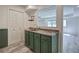 Basement wet bar featuring green cabinets, granite counters, and access to the main living space at 2921 Wickford Nw Dr, Kennesaw, GA 30152