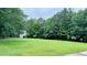 Expansive backyard featuring lush green grass and mature trees, offering a private and serene setting at 2100 Indian Shoals Dr, Loganville, GA 30052