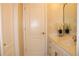 Bright bathroom features a sleek vanity with white countertop and stylish decor, plus a nearby door at 2100 Indian Shoals Dr, Loganville, GA 30052