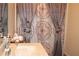 Bathroom featuring a decorative shower curtain, sink with marble counter, and a large mirror at 2100 Indian Shoals Dr, Loganville, GA 30052