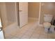 Functional bathroom featuring tile flooring, standard toilet, tub and convenient nearby door at 2100 Indian Shoals Dr, Loganville, GA 30052