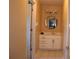 Bathroom featuring a cabinet style vanity, mirror with lighting and neutral tile floors at 2100 Indian Shoals Dr, Loganville, GA 30052