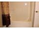 Bathroom with a tub-shower combination featuring a decorative shower curtain and convenient door access at 2100 Indian Shoals Dr, Loganville, GA 30052