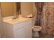 Bathroom featuring a shower curtain, sink with marble counter, and a standard toilet at 2100 Indian Shoals Dr, Loganville, GA 30052