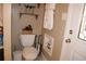 Bathroom featuring a toilet, tile flooring, white door with glass, and a wall shelf at 2100 Indian Shoals Dr, Loganville, GA 30052