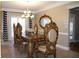 Dining room with ornate wooden table and chairs, chandelier, and tiled floor at 2100 Indian Shoals Dr, Loganville, GA 30052