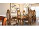 Dining room featuring ornate wooden table and chairs with adjacent modern art at 2100 Indian Shoals Dr, Loganville, GA 30052