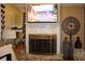 Close up on a fireplace with stone surround, decorative screen, and television above at 2100 Indian Shoals Dr, Loganville, GA 30052