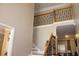 Bright foyer features staircase with decorative wrought iron railing and adjacent formal space at 2100 Indian Shoals Dr, Loganville, GA 30052