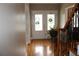 Foyer featuring hardwood floors, decorative french doors, and adjacent staircase at 2100 Indian Shoals Dr, Loganville, GA 30052