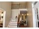 High ceiling foyer with hardwood floors and staircase with decorative iron spindles at 2100 Indian Shoals Dr, Loganville, GA 30052