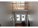 Two-story foyer featuring double doors with sidelight window and decorative wreaths at 2100 Indian Shoals Dr, Loganville, GA 30052