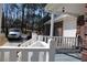 Inviting front porch with white railings, a porch swing, and ample space for relaxation at 2100 Indian Shoals Dr, Loganville, GA 30052