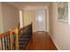 Upstairs hallway with hardwood floors and decorative railing at 2100 Indian Shoals Dr, Loganville, GA 30052