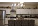 Bright kitchen with stainless steel appliances, tile backsplash, and an island with barstool seating at 2100 Indian Shoals Dr, Loganville, GA 30052