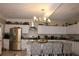 Open kitchen with stainless steel appliances, white cabinets, granite countertops, and island seating at 2100 Indian Shoals Dr, Loganville, GA 30052