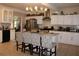 Bright kitchen with stainless steel appliances, tile backsplash, and an island with barstool seating at 2100 Indian Shoals Dr, Loganville, GA 30052