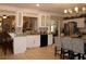 Bright kitchen with stainless steel appliances, tile backsplash, and an island with barstool seating at 2100 Indian Shoals Dr, Loganville, GA 30052