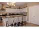 Bright kitchen with stainless steel appliances, tile backsplash, and an island with barstool seating at 2100 Indian Shoals Dr, Loganville, GA 30052