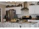 Bright kitchen with stainless steel appliances, tile backsplash, and an island with barstool seating at 2100 Indian Shoals Dr, Loganville, GA 30052