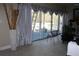 Living room with sliding glass doors to deck, tiled floors, and decorative floor vase at 2100 Indian Shoals Dr, Loganville, GA 30052