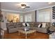 Spacious living room with a large comfortable sectional sofa and hardwood flooring at 2100 Indian Shoals Dr, Loganville, GA 30052
