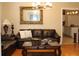 Living room featuring hardwood floors, comfortable seating, and view through to the kitchen at 2100 Indian Shoals Dr, Loganville, GA 30052