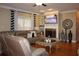 Comfortable living room featuring a fireplace with decorative screen, and adjacent window with patterned curtains at 2100 Indian Shoals Dr, Loganville, GA 30052