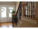 Staircase featuring decorative wrought iron spindles, and view to the front door at 2100 Indian Shoals Dr, Loganville, GA 30052