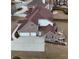 Aerial view of a brick home with an attached garage, a spacious deck, and a large driveway at 4850 Guilford Forest Sw Dr, Atlanta, GA 30331