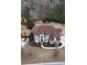 Aerial view of a stately home with a large, landscaped yard, circular driveway, and mature trees at 4850 Guilford Forest Sw Dr, Atlanta, GA 30331