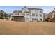 Expansive home back exterior with large deck and sprawling green backyard at 4850 Guilford Forest Sw Dr, Atlanta, GA 30331