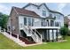 Spacious backyard featuring a multi-level deck with stairs leading to the lawn and landscaping at 4850 Guilford Forest Sw Dr, Atlanta, GA 30331