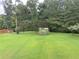 Expansive backyard featuring lush green lawn and mature trees, perfect for outdoor activities at 4850 Guilford Forest Sw Dr, Atlanta, GA 30331