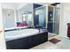 Luxurious bathroom features a soaking tub, glass-enclosed shower, and elegant vanity with marble countertops at 4850 Guilford Forest Sw Dr, Atlanta, GA 30331