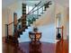 Welcoming foyer with hardwood floors and staircase featuring wrought iron railings at 4850 Guilford Forest Sw Dr, Atlanta, GA 30331
