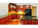 Well-appointed kitchen with granite countertops, rich wood cabinets and modern black appliances at 4850 Guilford Forest Sw Dr, Atlanta, GA 30331