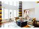 Spacious living room with high ceilings, large windows, and a comfortable seating area with a decorative rug at 4850 Guilford Forest Sw Dr, Atlanta, GA 30331